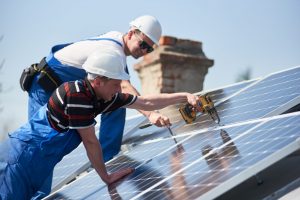 employees installing solar panels