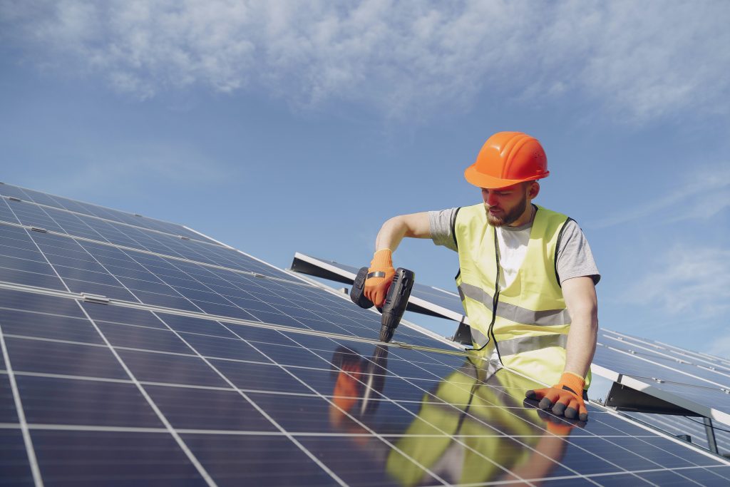 solar installer installing commercial panels