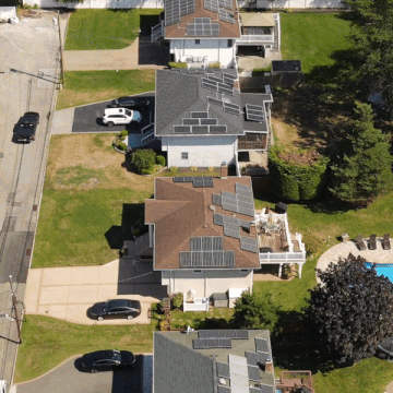 birds eye view of solar installs in a residential neighborhood
