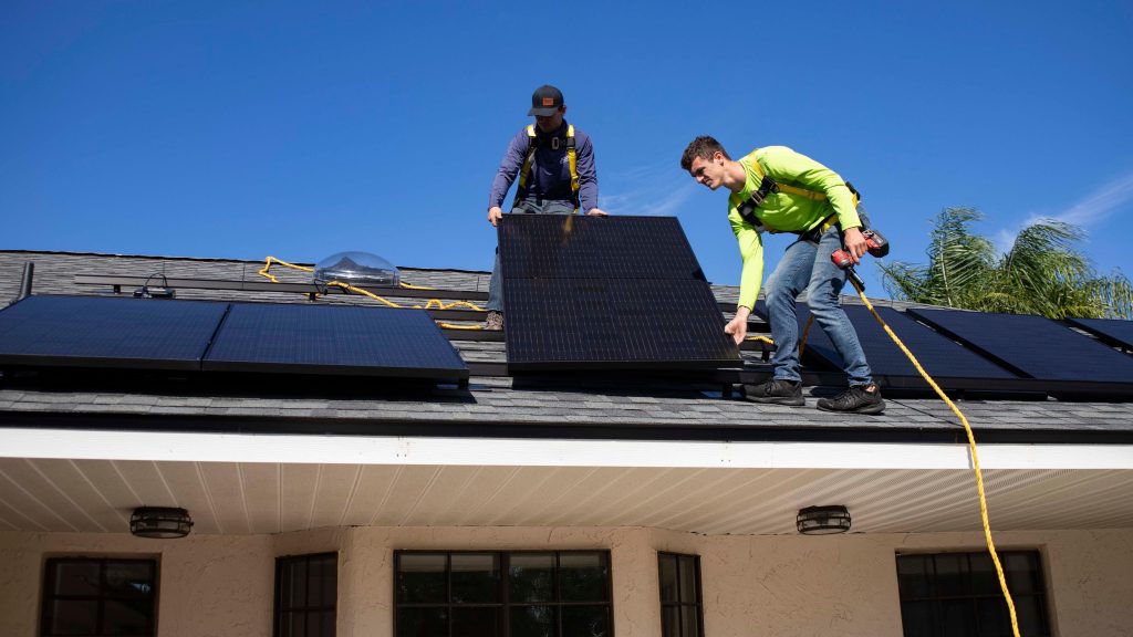 Surf clean energy installation crew installing solar panels on a New York residential roof