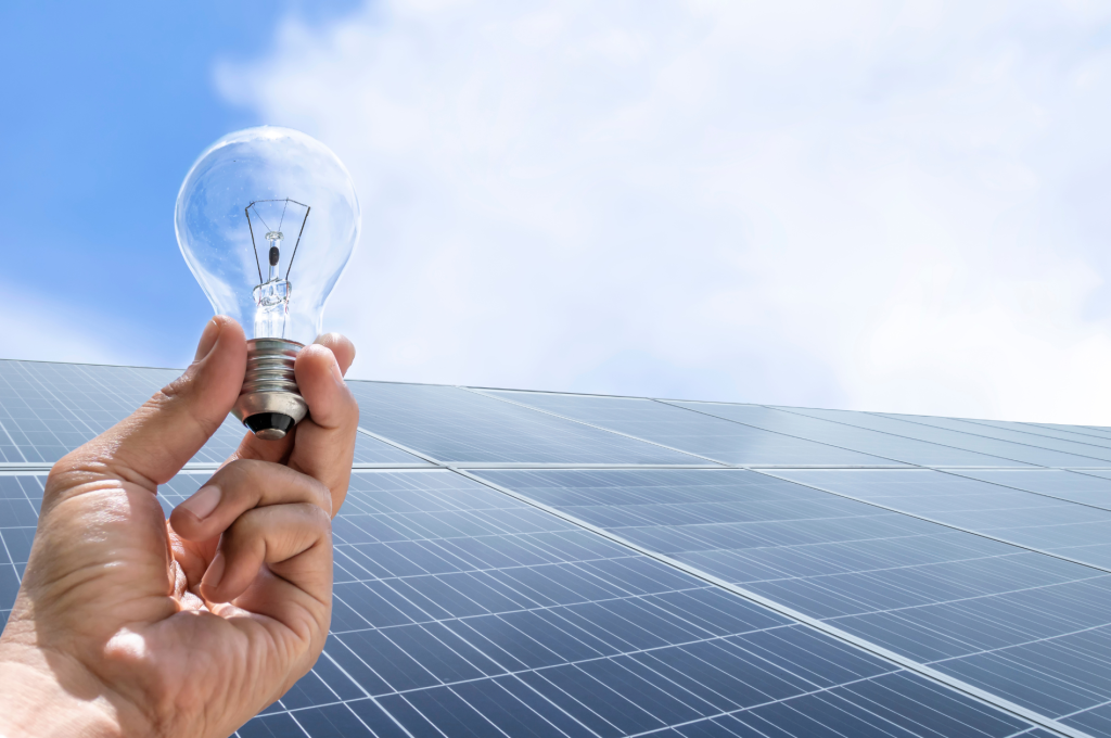 Graphic of a man holding a lightbulb over solar panels